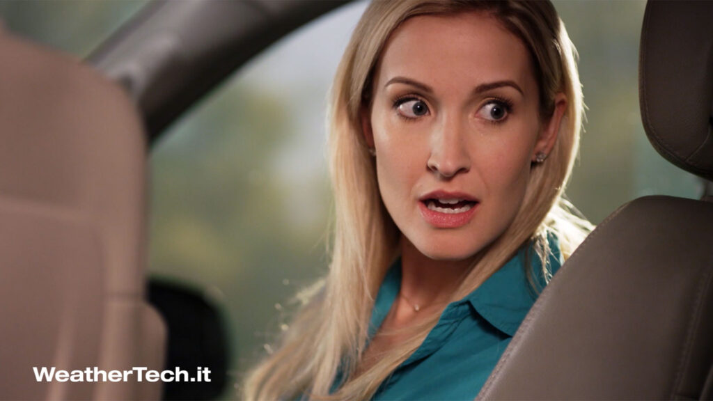 Woman reacting with surprise inside a car in WeatherTech Step in It preroll video campaign